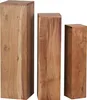 Three wooden pedestals of varying heights are arranged side-by-side against a white background. Produktbild-Vorschau