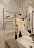 A modern bathroom with a sink, faucet, towel rack, and decorative lighting. Produktbild-Vorschau