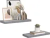 Two grey floating shelves are displayed against a white background, each decorated with minimalist home decor items. Náhled obrázku produktu