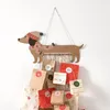 A hanging advent calendar shaped like a dachshund, with numbered paper bags attached. Anteprima dell’immagine prodotto