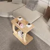 A C-shaped side table with donuts and coffee cups on it, placed next to a sectional sofa. Náhled obrázku produktu