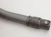 A close-up shot of a flexible vacuum cleaner hose with a connector and release button. Produktbild-Vorschau
