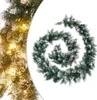 A green Christmas garland with pine cones and artificial snow, coiled on a white background. Produktbild-Vorschau
