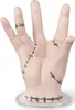 A prosthetic hand with stitches, standing on a clear base. Náhľad obrázku produktu