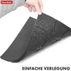 A hand is holding up a piece of a dark gray, textured mat, revealing a lighter gray, smooth underside. The mat appears to be a protective or impact-absorbing material. Anteprima dell’immagine prodotto