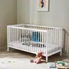 A nursery room with a white crib and toys. Produktbild-Vorschau