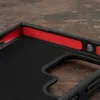 Close-up view of the interior of a black phone case with red accents and embossed text. Anteprima dell’immagine prodotto