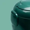 A close-up of a green rice cooker lid and handle. Produktbild-Vorschau