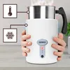 Hands holding a white electric milk frother with a silver top and a black handle. Steam is rising from the top. Icons for temperature and snowflake are shown to the left. Produktbild-Vorschau