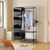 A black fabric wardrobe with clothes hanging on a rack and storage boxes on the side, placed in a room with a bed and window. Produktbild-Vorschau