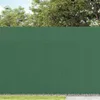 A green PVC garden fence is shown outdoors, with trees and sky in the background. Anteprima dell’immagine prodotto
