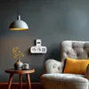 A living room scene with a power strip mounted on the wall, a chair, and a side table with a vase and cup. Produktbild-Vorschau