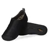 A pair of black slip-on shoes shown from a diagonal angle against a white background. Produktbild-Vorschau