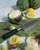 A Santoku knife is shown with artichokes and lemons, suggesting food preparation. Náhľad obrázku produktu