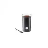 A black electric coffee grinder with ground coffee inside, placed on a white background next to a small brush. Produktbild-Vorschau