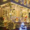 A house decorated with Christmas lights and garlands for the holidays. Produktbild-Vorschau