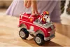 A child's hand is pressing a button on a red toy fire truck with a dog character inside. Náhľad obrázku produktu