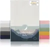 A product shot of baby fitted sheets in various colors, with a main product shot of an ivory fitted sheet in the center. Produktbild-Vorschau