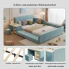 A child's upholstered bed with integrated desk and stool, shown in a room setting with decorative elements. Voir les images du produit