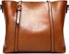 A close-up studio shot of a brown leather handbag. Produktbild-Vorschau