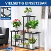 A multi-tiered black metal plant stand filled with various potted plants, placed indoors next to a sofa and sheer curtains. Podgląd zdjęcia produktu