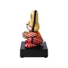 A side view of a colorful, stylized rabbit figurine sitting on a black base. Produktbild-Vorschau