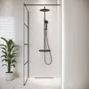 A modern black shower fixture and glass partition in a bathroom with white tiled walls and marble flooring. Anteprima dell’immagine prodotto