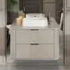 A modern bathroom vanity with a double sink and fluted drawers, reflected in a mirror. Anteprima dell’immagine prodotto
