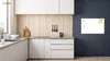 A modern kitchen with white cabinets and a wooden backsplash, featuring a magnetic whiteboard on a dark gray wall. Podgląd zdjęcia produktu