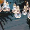 A string of clear LED light bulbs hanging outdoors, with palm tree silhouettes in the background. Anteprima dell’immagine prodotto
