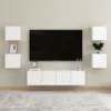 A modern living room setup with a wall-mounted TV and media console, flanked by floating shelves. Voir les images du produit