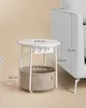 A white round side table with a built-in power strip and USB ports, next to a white couch. Náhled obrázku produktu