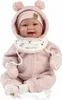 A baby doll dressed in a pink outfit, sitting down. Podgląd zdjęcia produktu
