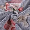 A close-up of a soft, plush blanket with a Christmas-themed pattern. Náhled obrázku produktu