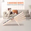 A dog is lying on a couch next to a wooden pet ramp that is set up at an angle. Produktbild-Vorschau