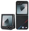 A flip phone case with a carbon fiber texture and BMW branding, shown in both open and closed states. Produktbild-Vorschau