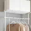 A white clothing rack with several garments hanging on it, and two white storage boxes on the top shelf. Produktbild-Vorschau