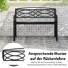 A black metal garden bench is shown in front of a tiled wall and patio. Podgląd zdjęcia produktu
