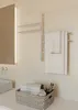 A bathroom scene with a towel warmer, towels, and toiletries. Podgląd zdjęcia produktu
