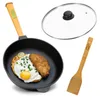 A frying pan with food, a glass lid, and a spatula, presented on a white background. Produktbild-Vorschau