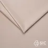 A close-up view of beige fabric, folded to show texture and depth. A logo is visible in the bottom right corner. Náhled obrázku produktu