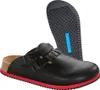 A pair of black Birkenstock clogs with a red sole and a separate sole shown. Anteprima dell’immagine prodotto