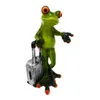 A figurine of a green frog standing next to a suitcase, appearing to be traveling. Produktbild-Vorschau