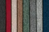 A close-up, top-down view of several carpet tile samples arranged vertically in a row. Produktbild-Vorschau