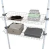 Two wire storage baskets are attached to a white telescopic pole system, holding various items. Produktbild-Vorschau