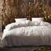 A bed with white bedding is set against a backdrop of dried reeds and flowers. Produktbild-Vorschau