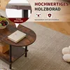 A close-up view of a dark brown wooden coffee table with a book and fruit on it, placed on a textured rug. Náhled obrázku produktu