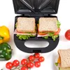 A sandwich maker with two sandwiches inside, surrounded by fresh vegetables. Náhľad obrázku produktu