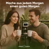 A couple enjoying coffee on a balcony with a coffee maker in the background. Anteprima dell’immagine prodotto