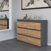 A modern dresser with a gray matte finish and oak wood drawers, displayed in a room with a mirror and artwork. Náhľad obrázku produktu